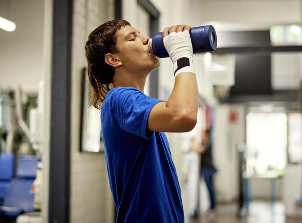 Human drinking fresh water from a bottle