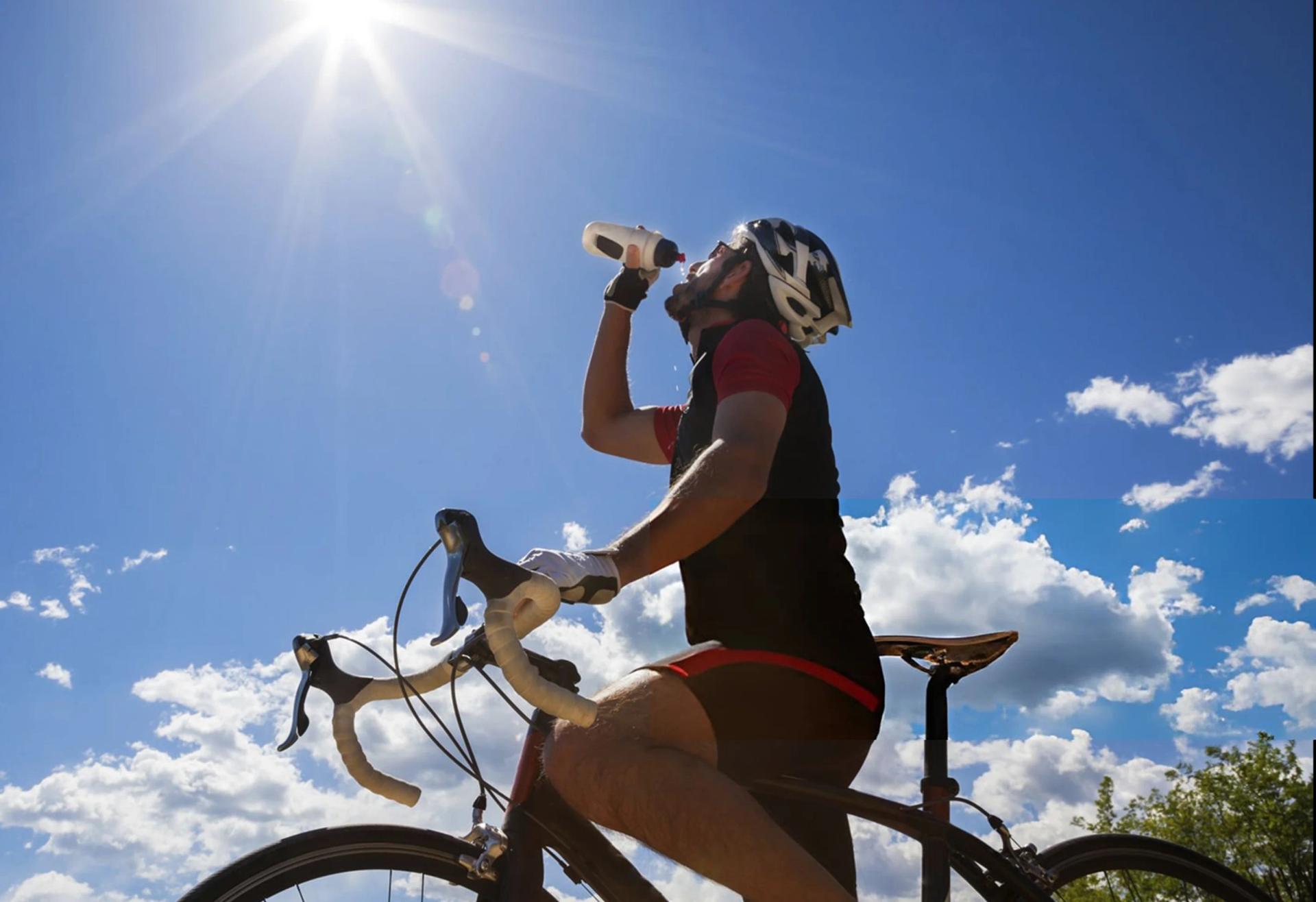 Cyclist drinking water outdoors